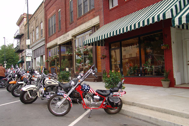 Motorcycles sit in front of local shops